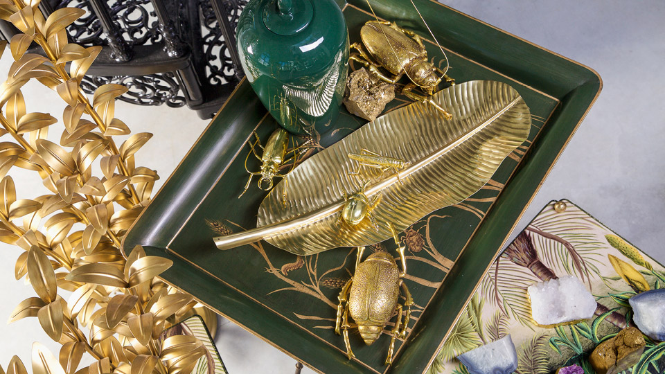 Gold-colored jewelry and decorative elements on a green shell
