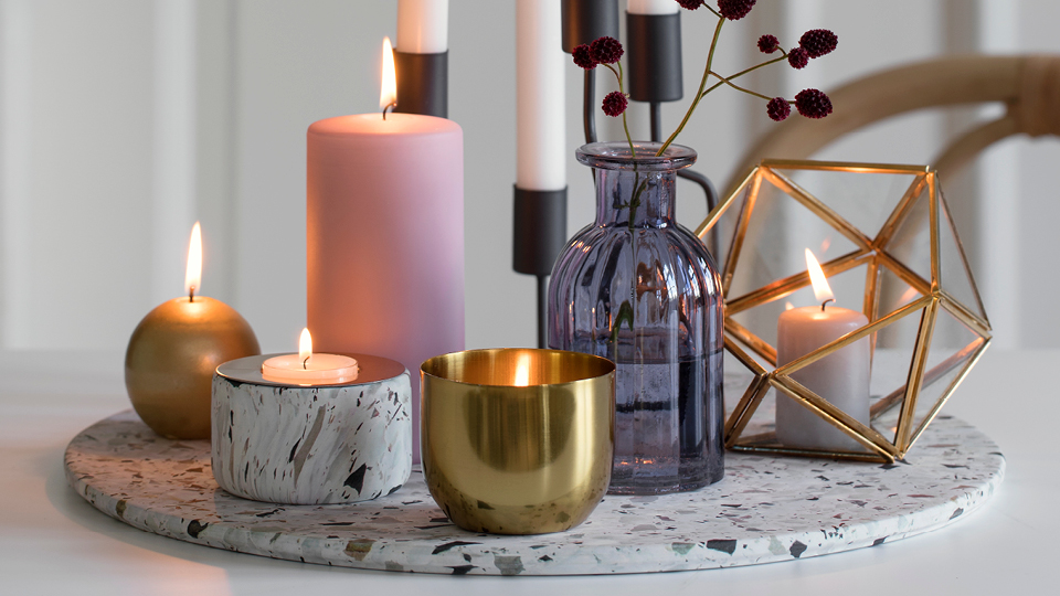 Pink, white and golden candles of varying shapes and sizes