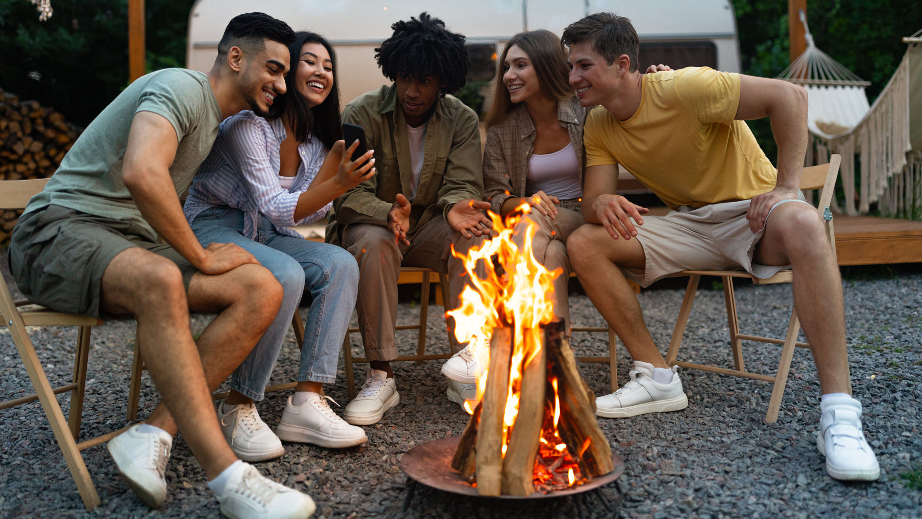 Young people sitting around a campfire