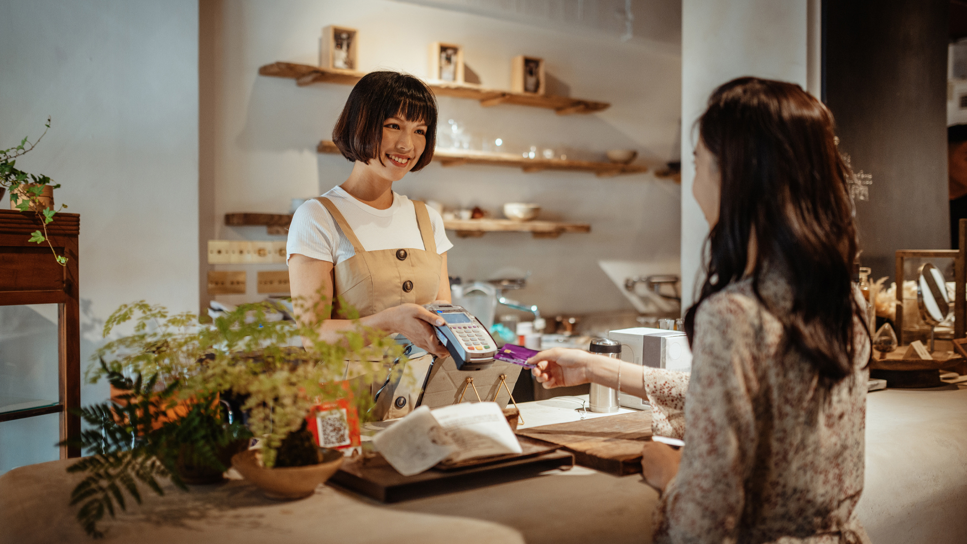 Woman pays contactless in retail