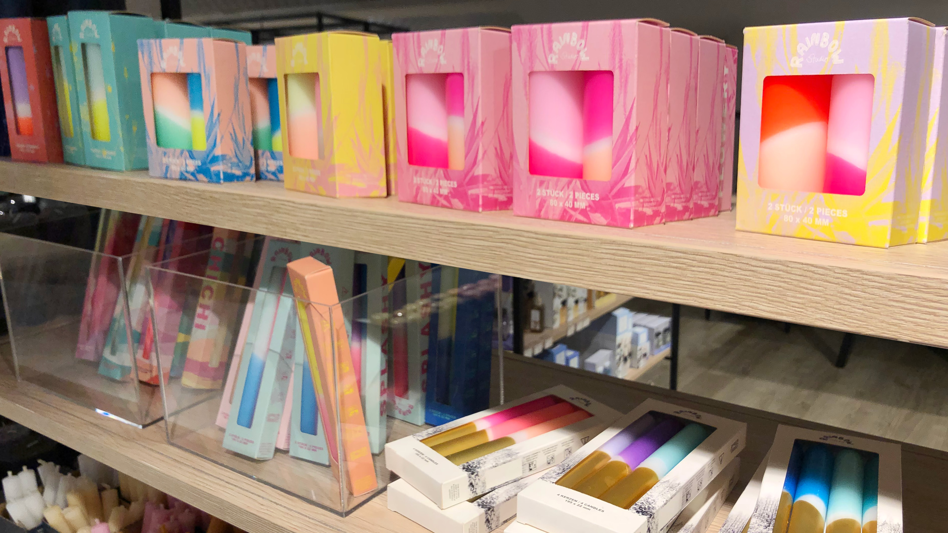 Colourful candles on a shelf