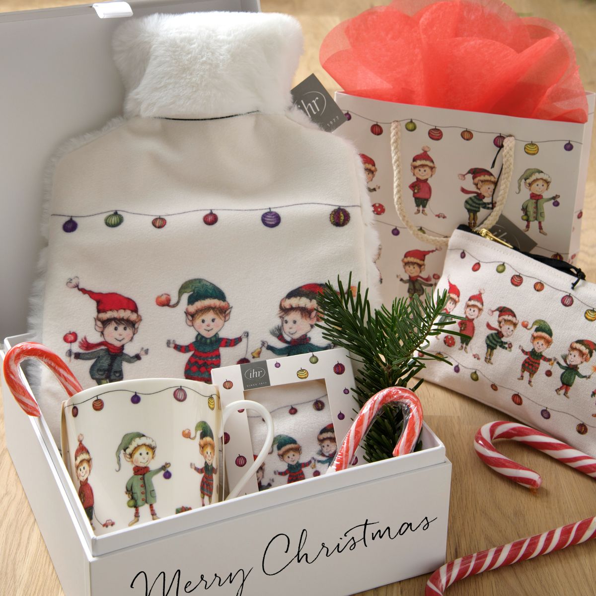 Hot-water bottle, zip bag, shopping bag, bone china mug, napkins, tea glass “Elves at Work” by IHR