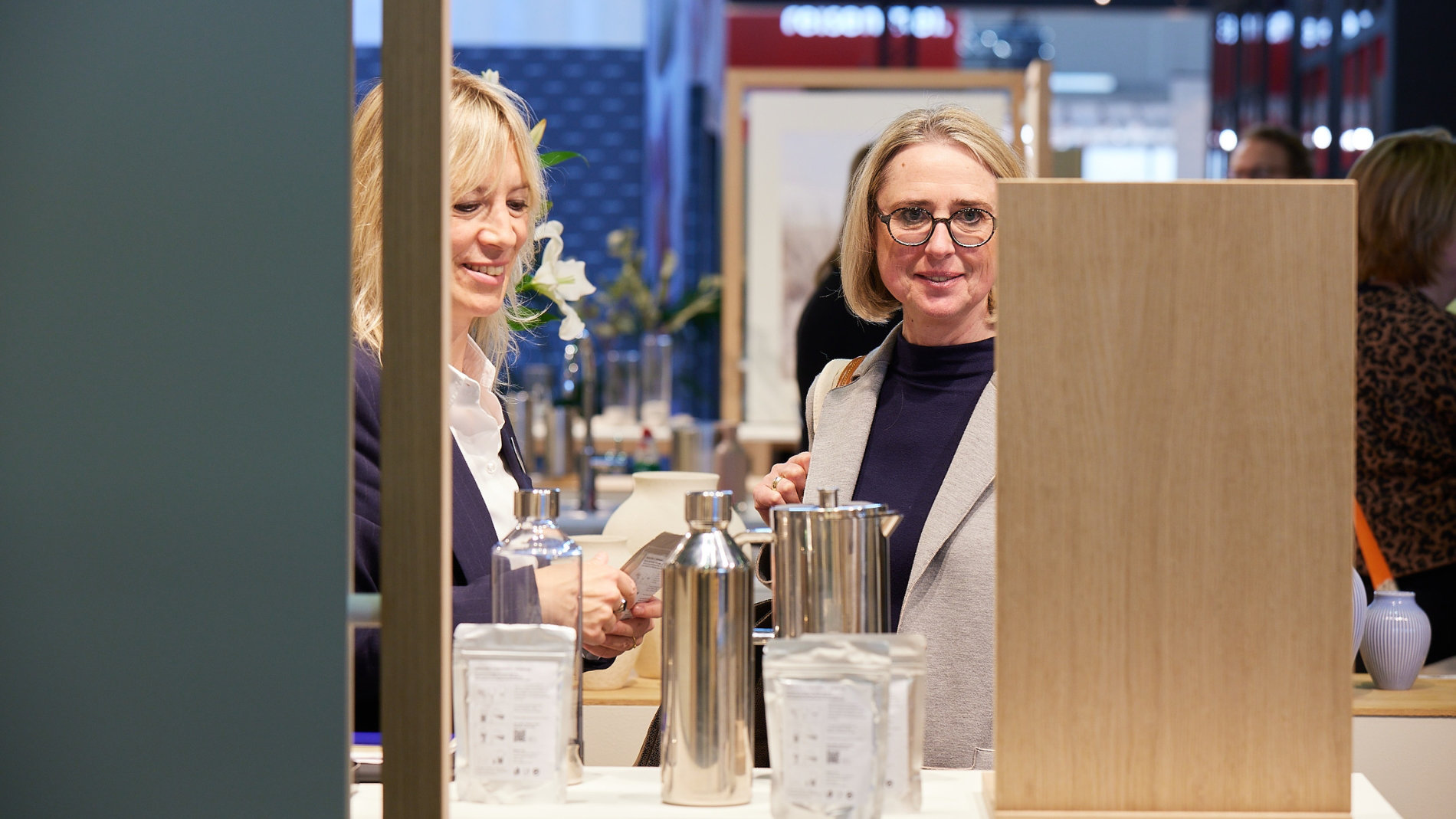Two women in front of an exhibition stand