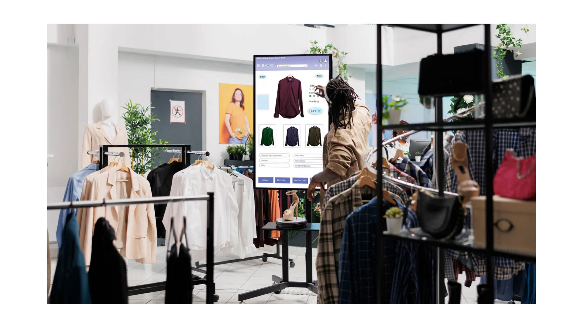 Customer using interactive display in fashion store to select products, example of digitalisation in retail.