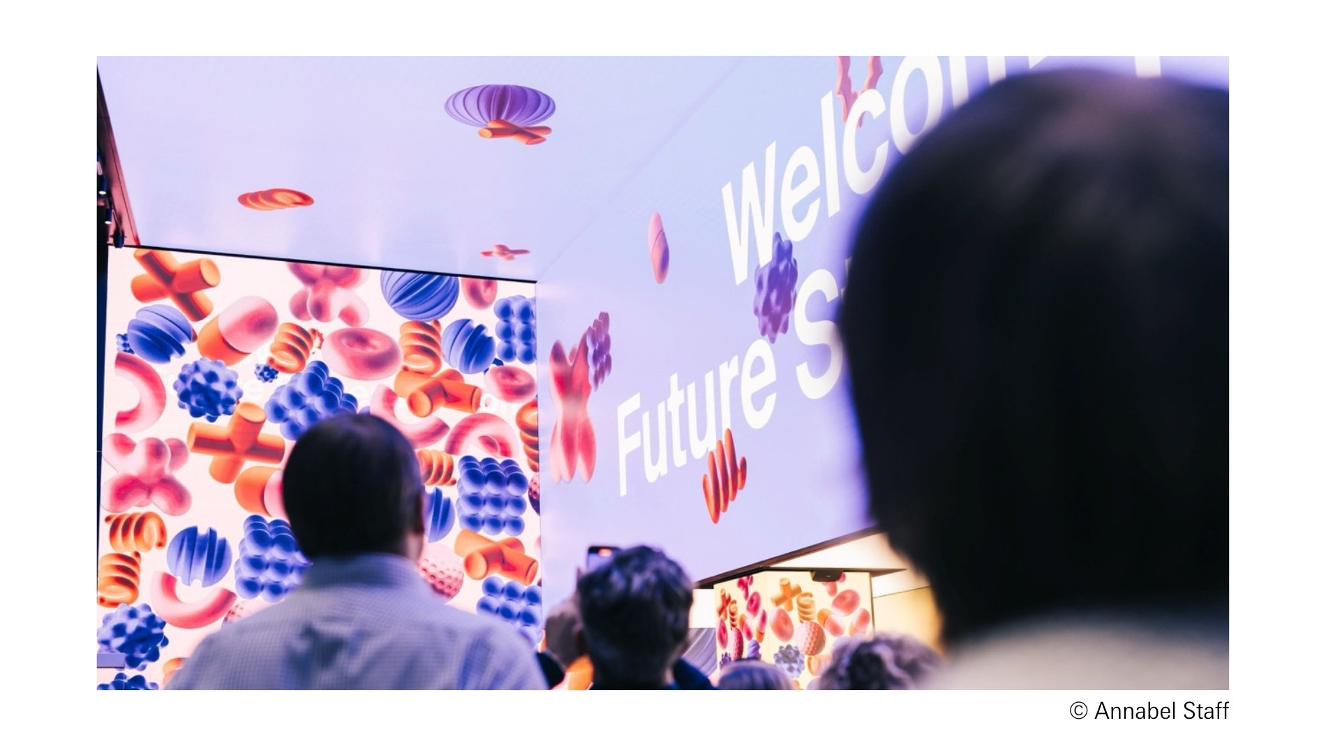 People in a room with screens