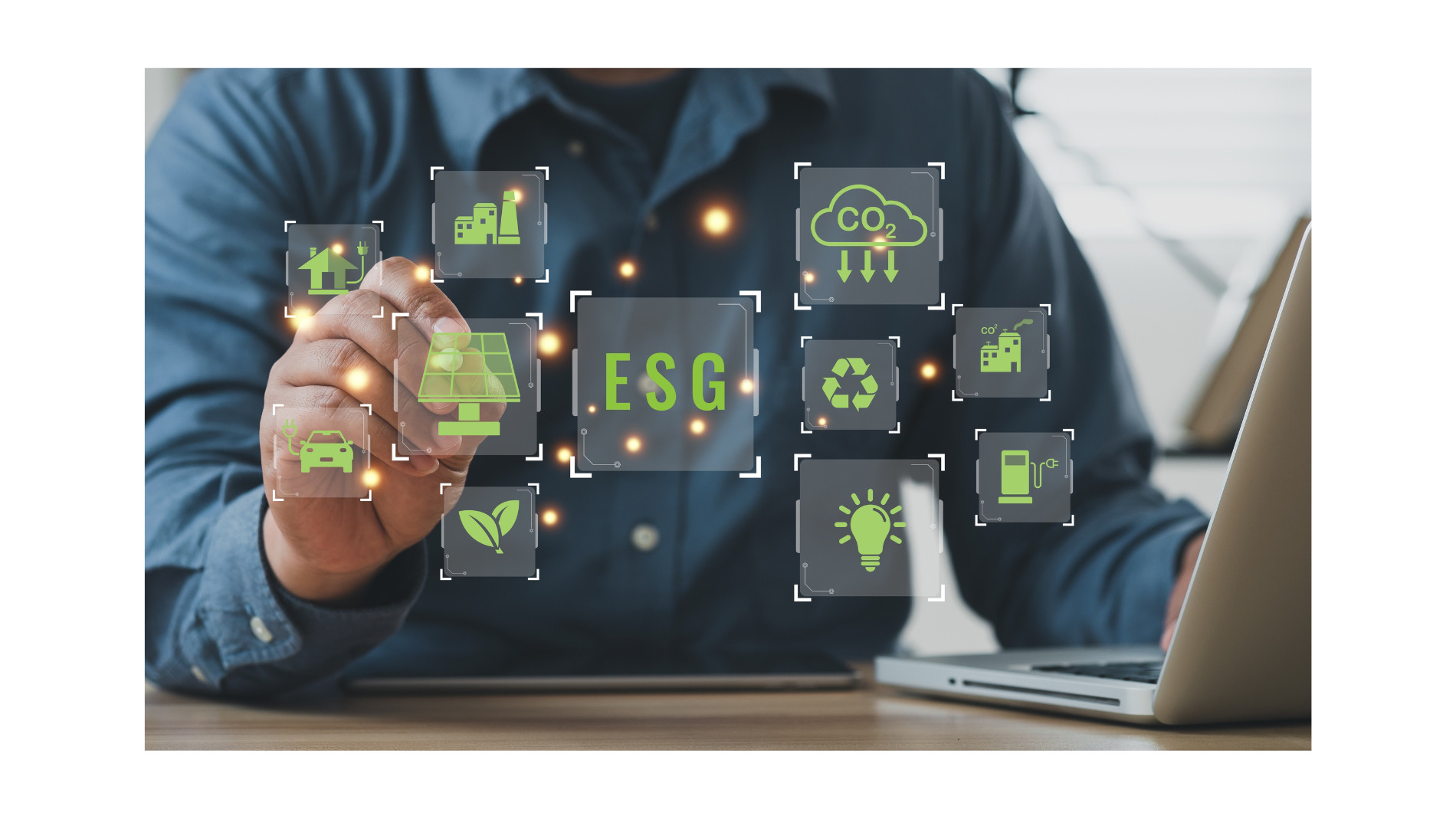 Man at laptop with virtual icons in front of him