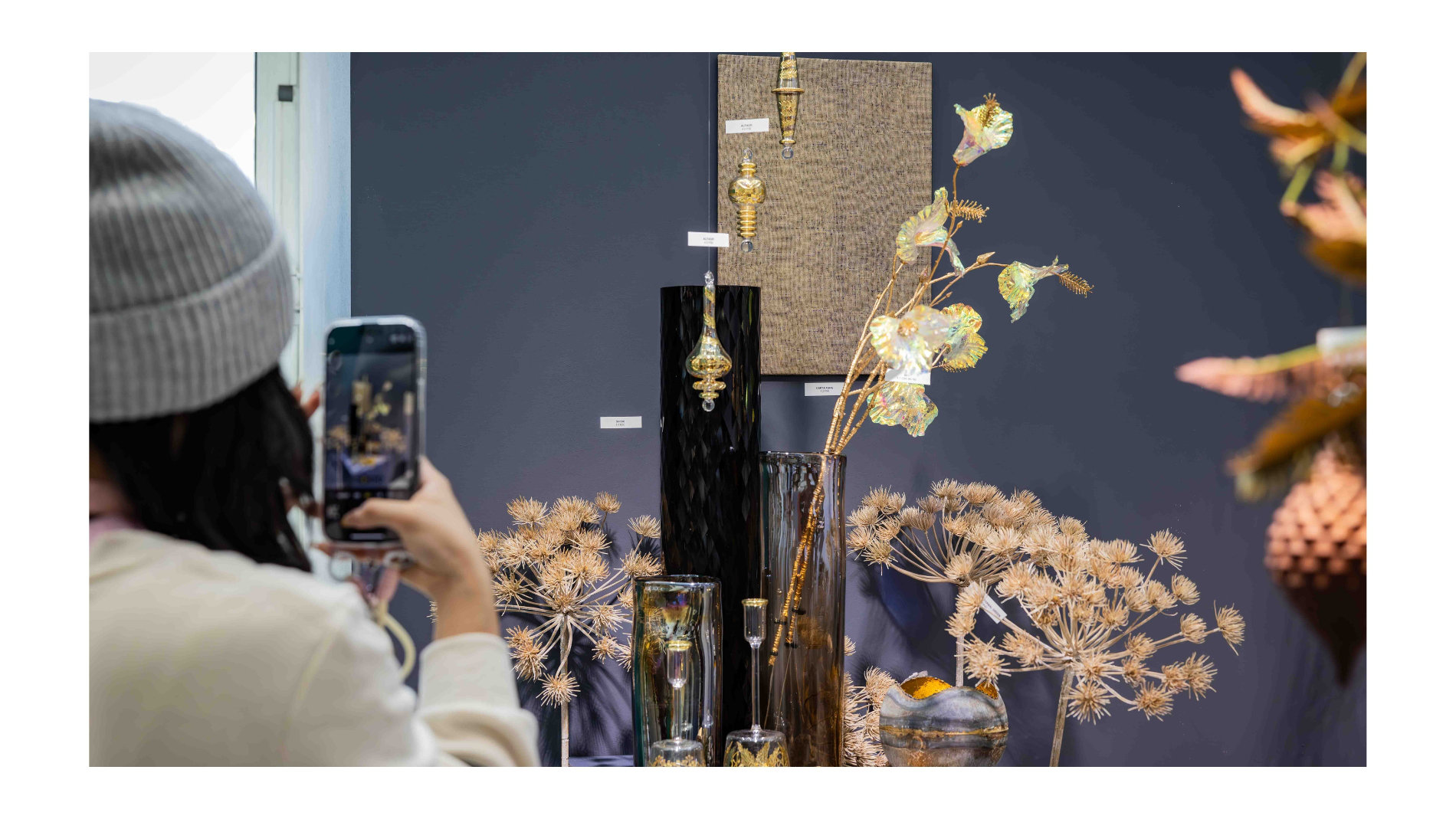 Woman photographing exhibition pieces